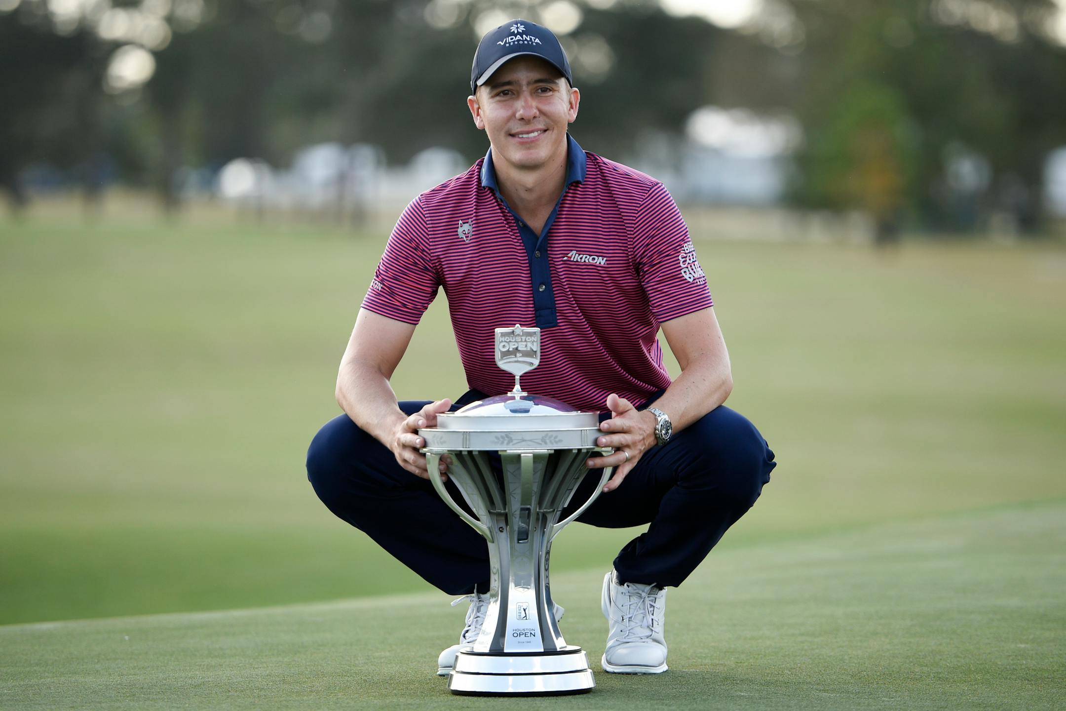 Carlos Ortiz poses with the champions trophy after winning the Houston Open
