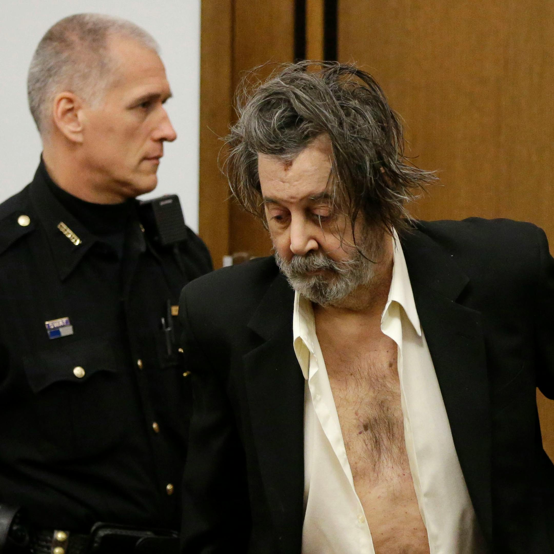 Bobby Thompson, who authorities have identified as Harvard-trained attorney John Donald Cody, enters the courtroom Tuesday, Nov. 12, 2013, in Cleveland. Thompson, the mysterious defendant charged in a $100 million, cross-country veterans charity fraud, has balked at testifying at his trial and has asked for time to decide. Thompson is charged with looting the United States Navy Veterans Association charity that he ran in Tampa, Fla. (AP Photo/Mark Duncan)