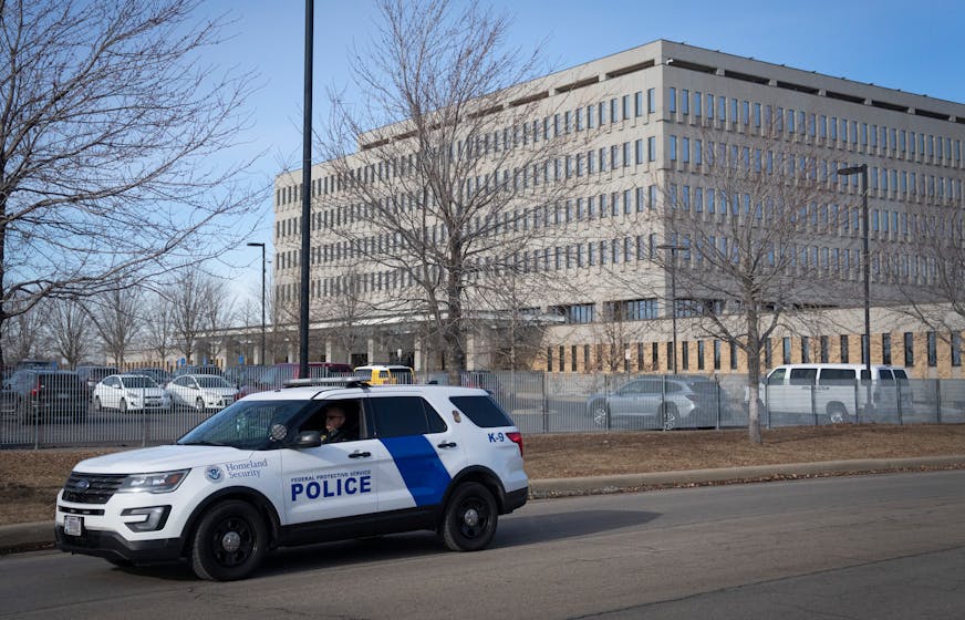 A homeland security officer drives past the Bishop Henry Whipple Federal Building in Minneapolis, Minn., on Wednesday, January 29, 2025