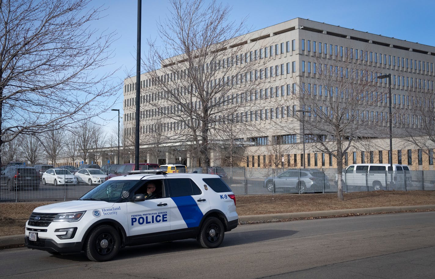 A homeland security officer drives past the Bishop Henry Whipple Federal Building in Minneapolis, Minn., on Wednesday, January 29, 2025