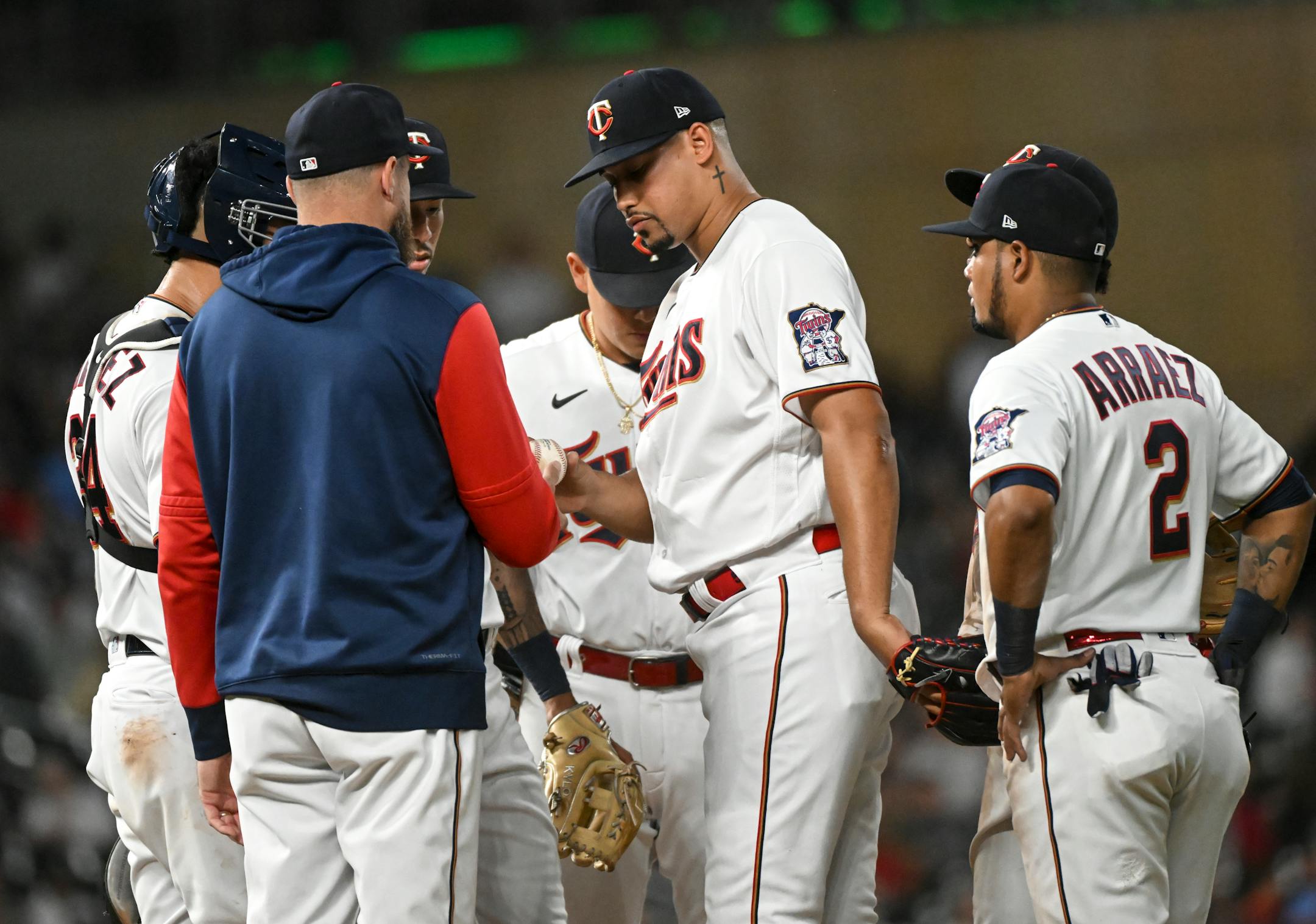 Minnesota Twins relief pitcher Jhoan Duran (59) hands manager Rocco Baldelli (5) the ball as he is pulled off the mound in the top of the 7th inning.