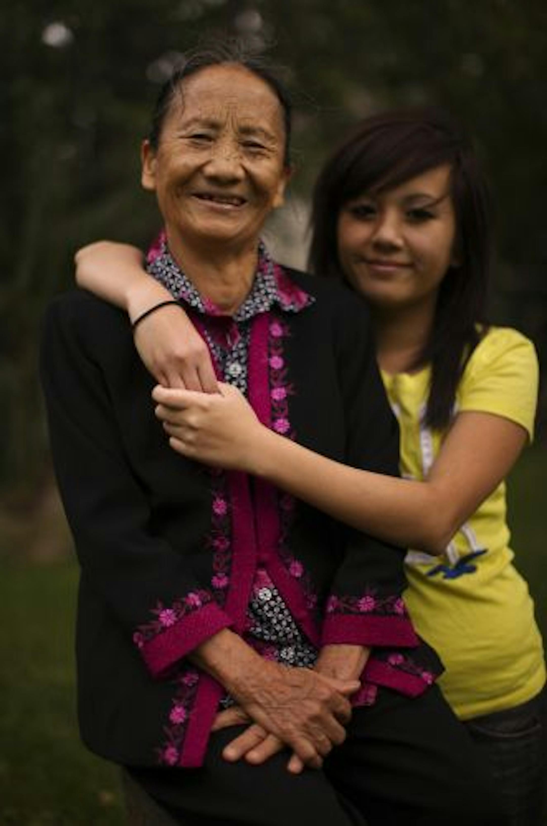 Lee Xiong and her granddaughter, Sandra Yang, 13, in the back yard of their Brooklyn Park home Friday afternoon.