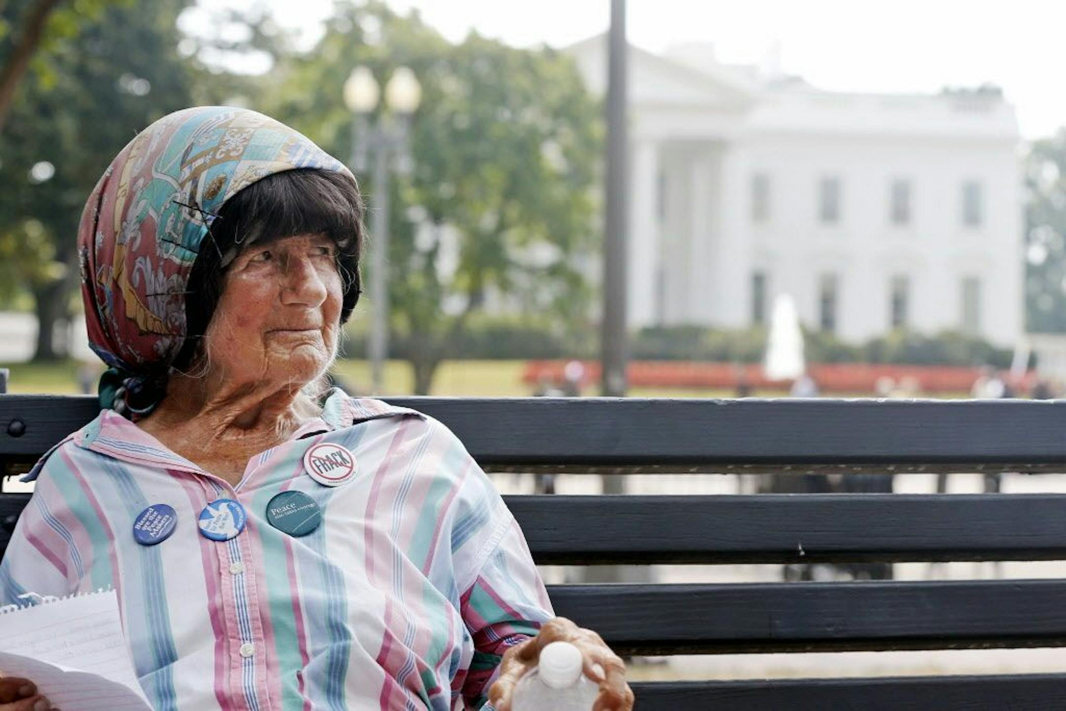 FILE - In this Sept. 12, 2013 file photo, Concepcion Picciotto, who held a constant peace vigil in Lafayette Park across from the White House, sits on a park bench.