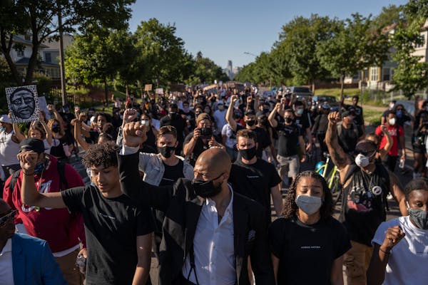 Former NBA player Royce White, center, leads a march in Minneapolis in June 2020 protesting police brutality and the killing of George Floyd.