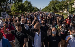 Former NBA player Royce White, center, leads a march in Minneapolis in June 2020 protesting police brutality and the killing of George Floyd.