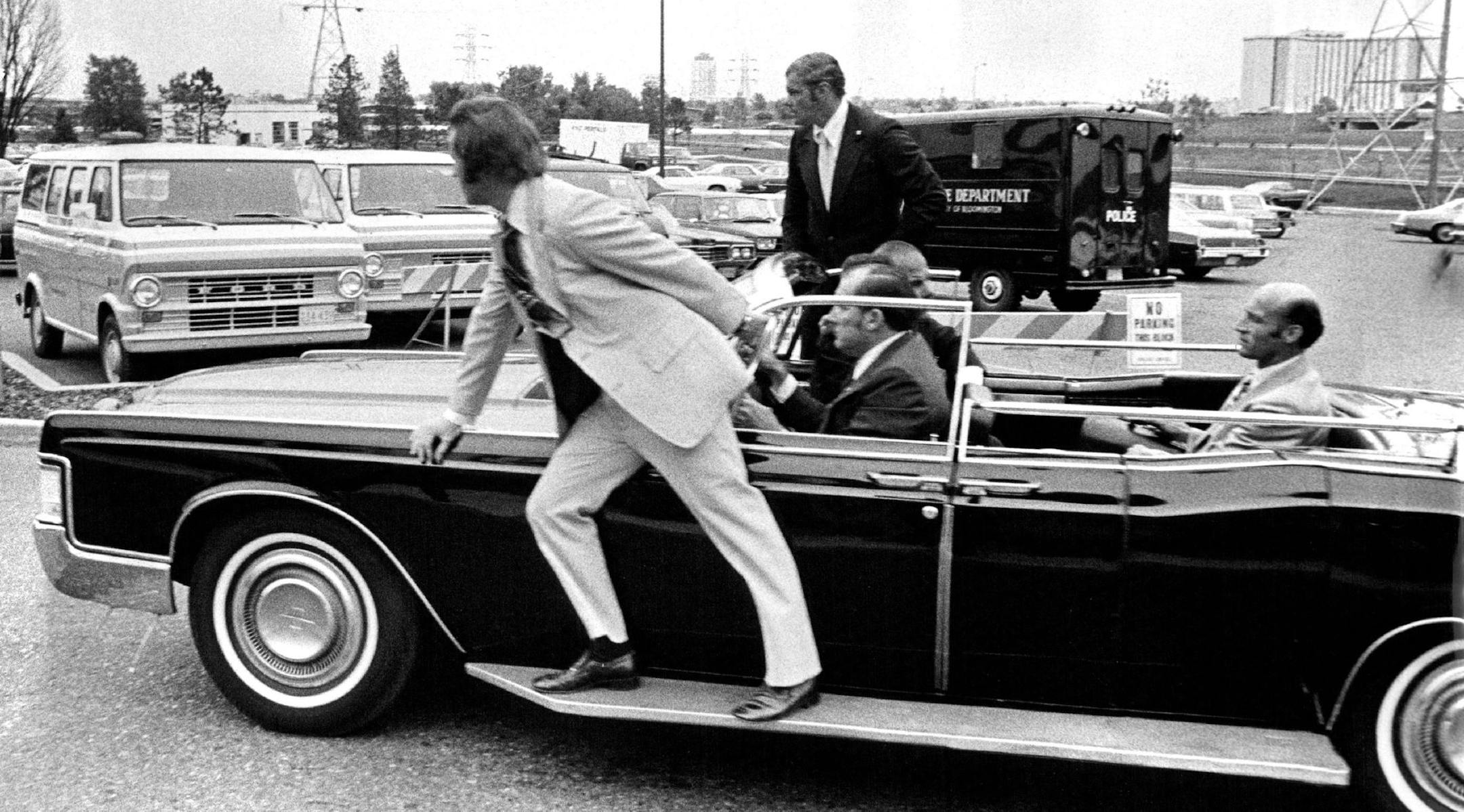 August 20, 1975 Secret Service men fell in behind Ford's limousine as he left Bloomington Politically, ,President Gerald Ford's visit to the Twin Cities yesterday may have been beneficial, both to the President and to local Republicans. But to the hundreds of local police, sheriff's deputies and his on palace guards, the Secret Service, the visit ended none to soon. Security measures were tough, from the airport where he landed to the Minneapolis Auditorium and convention gall where he addressed