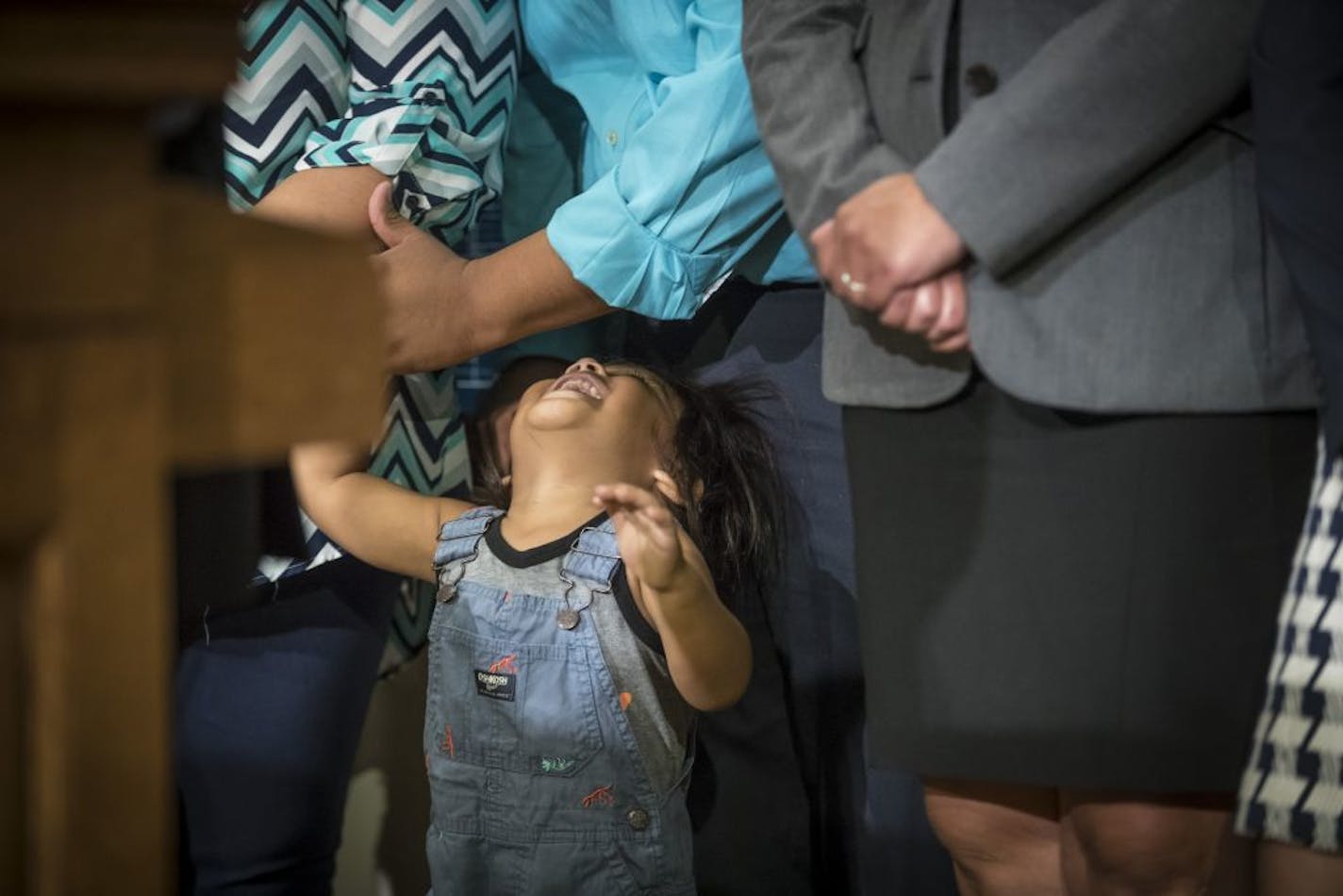 Uriel Rosales Tlatenchi (in blue shirt), a DACA recipient, played with his two-year-old son Atzel Rosales Lopez to keep him happy during a "DACA Five Years Later" press conference by NAVIGATE MN and the Minnesota-Dakotas Chapter of the American Immigration Lawyers Association on Tuesday, August 15, 2017 at the Minnesota State Capitol in St. Paul, Minn.