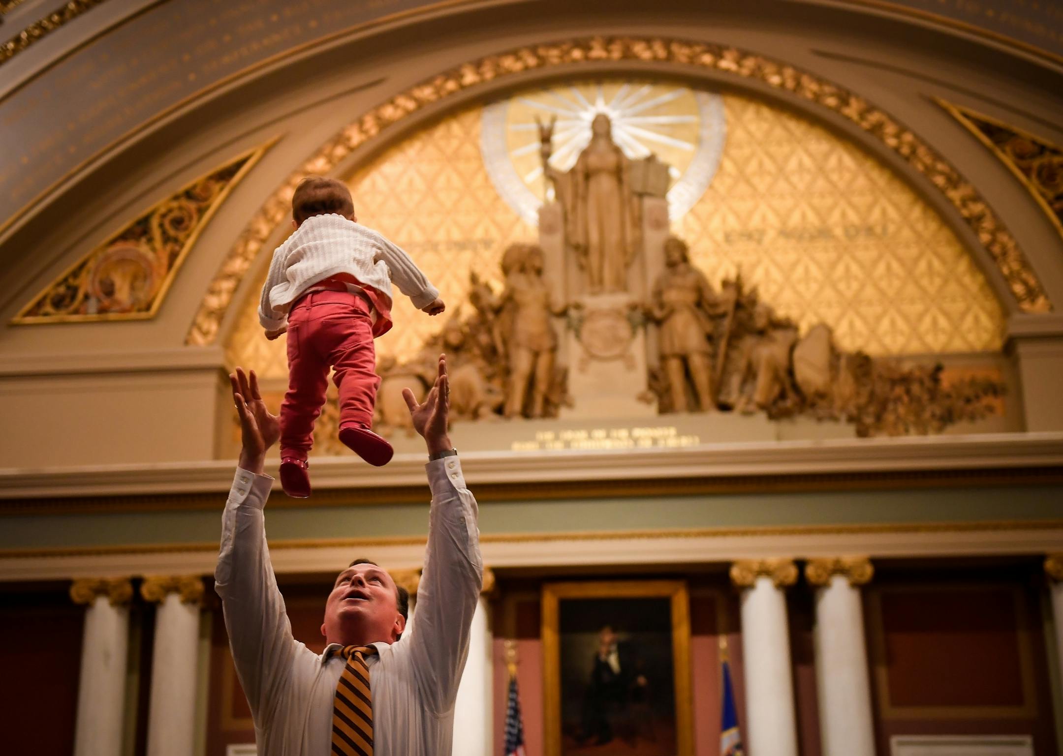 Rep. John Lesch tossed his infant daughter, Elanor, into the air during a recess of the legislative special session Tuesday afternoon at the state capitol.