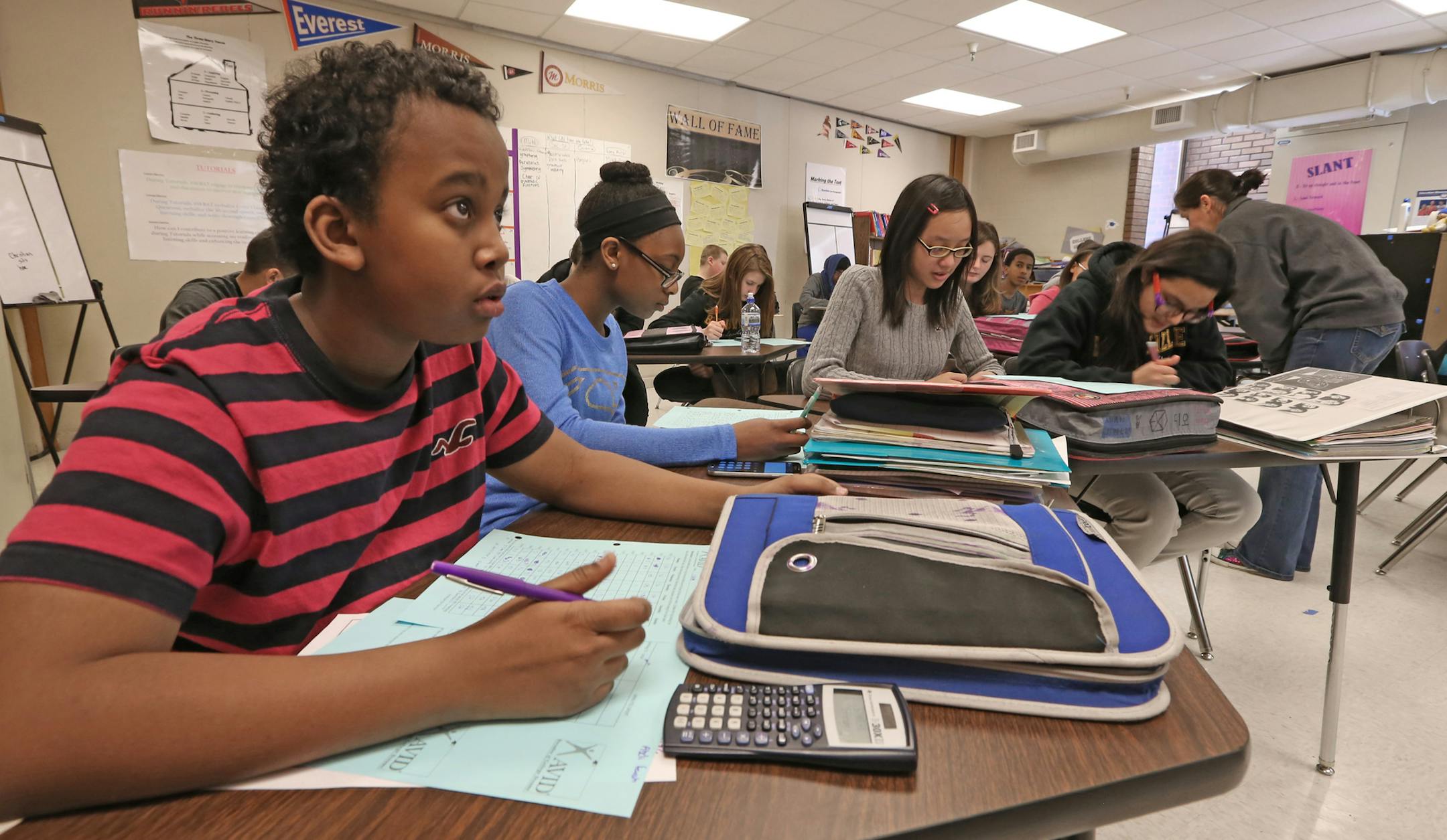 (left to right) Abdi Farah, Aryonna Edwards, Catlynn Dang and Donna Garzon worked on problems, as teacher Amy Olson gave out assignments at the end of her AVID (advancement via individual determination ) class at Nicollet Junior High School on 1/29/14. The Burnsville and Lakeville districts have recently created their third integration plan via their Multi-District Collaborative Council. The plans are designed to encourage students from each district to attend school in the other, balancing out