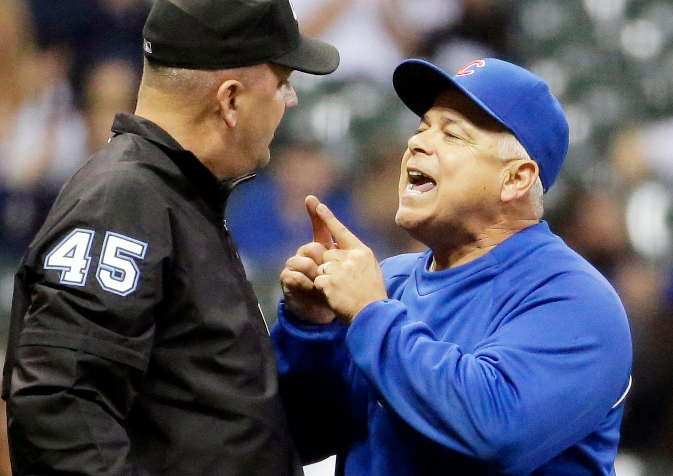 FILE - In this Sept. 26, 2014, file photo, Chicago Cubs manager Rick Renteria, right, argues with umpire Jeff Nelson during the eighth inning of a baseball game against the Milwaukee Brewers, in Milwaukee. The Cubs have fired Renteria after one season to pursue former Tampa Bay manager Joe Maddon.