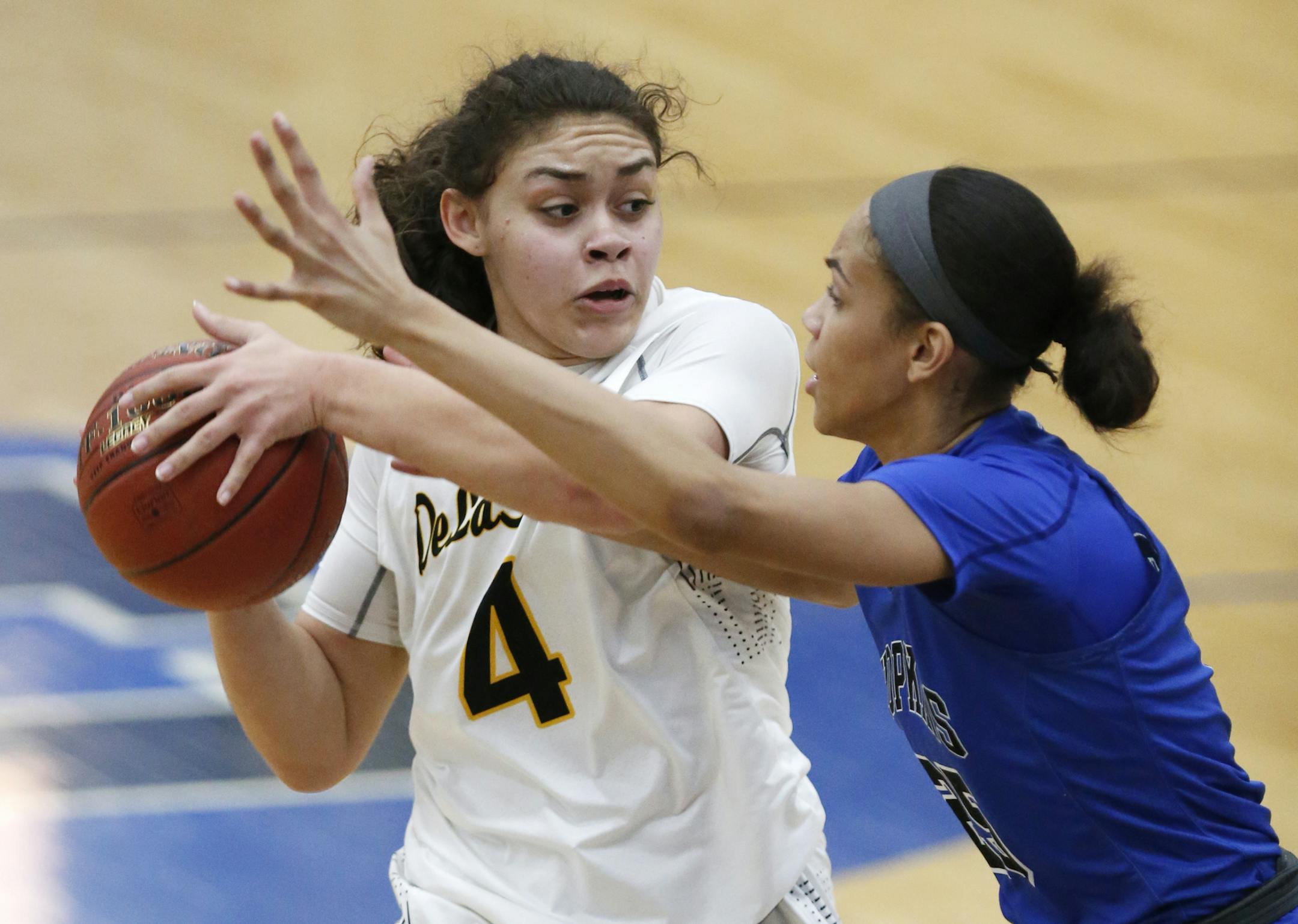 Olivia Travis, right, of DeLaSalle looks for a pass around the defense of Angie Hammond of Hopkins. ] LEILA NAVIDI ï leila.navidi@startribune.com BACKGROUND INFORMATION: DeLaSalle High School girls basketball plays at Hopkins High School on Tuesday, January 30, 2018. DeLaSalle won the game 67-61.
