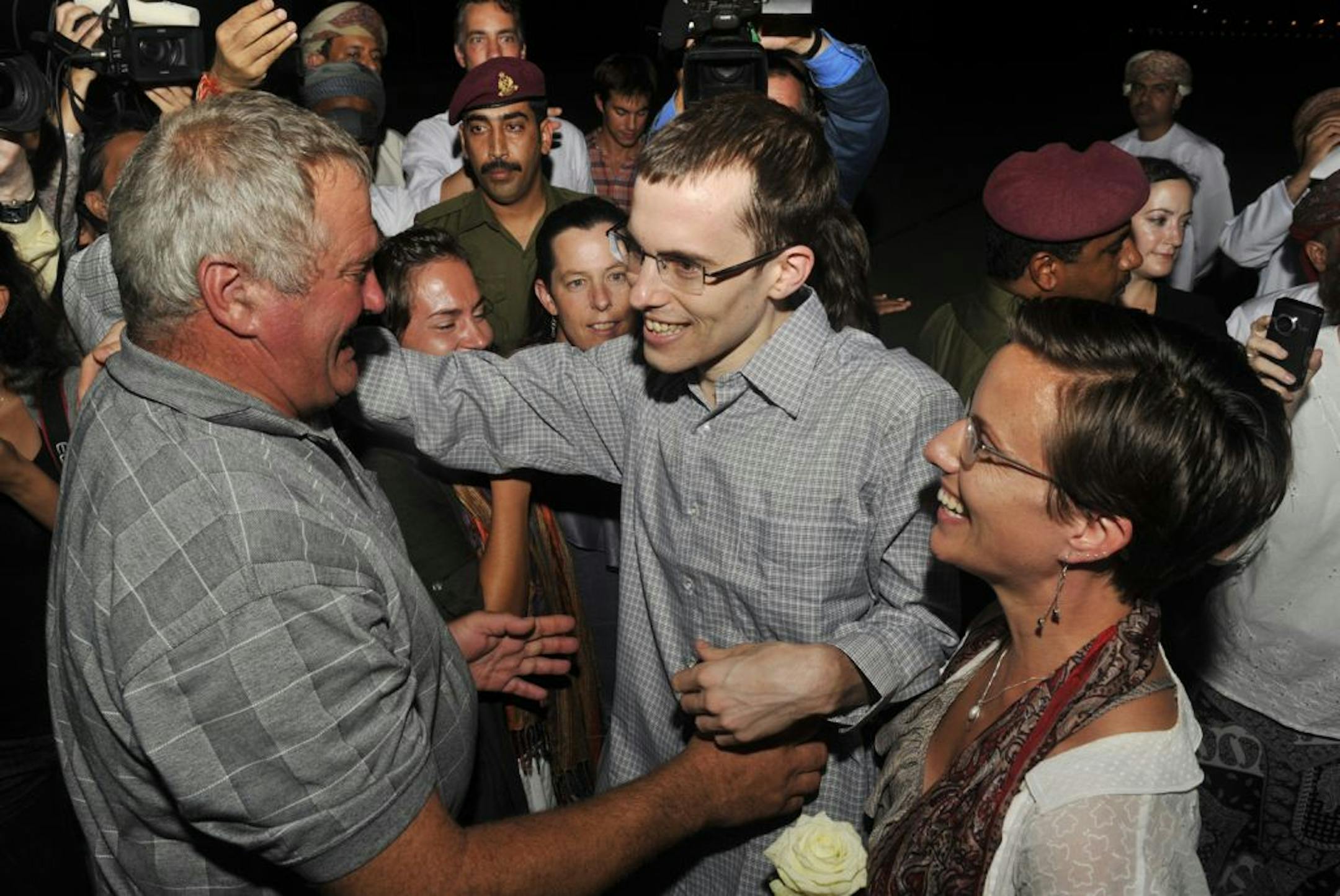 Freed American Shane Bauer, center, greeted his father, Al Bauer, as his fiance Sarah Shourd looked on.