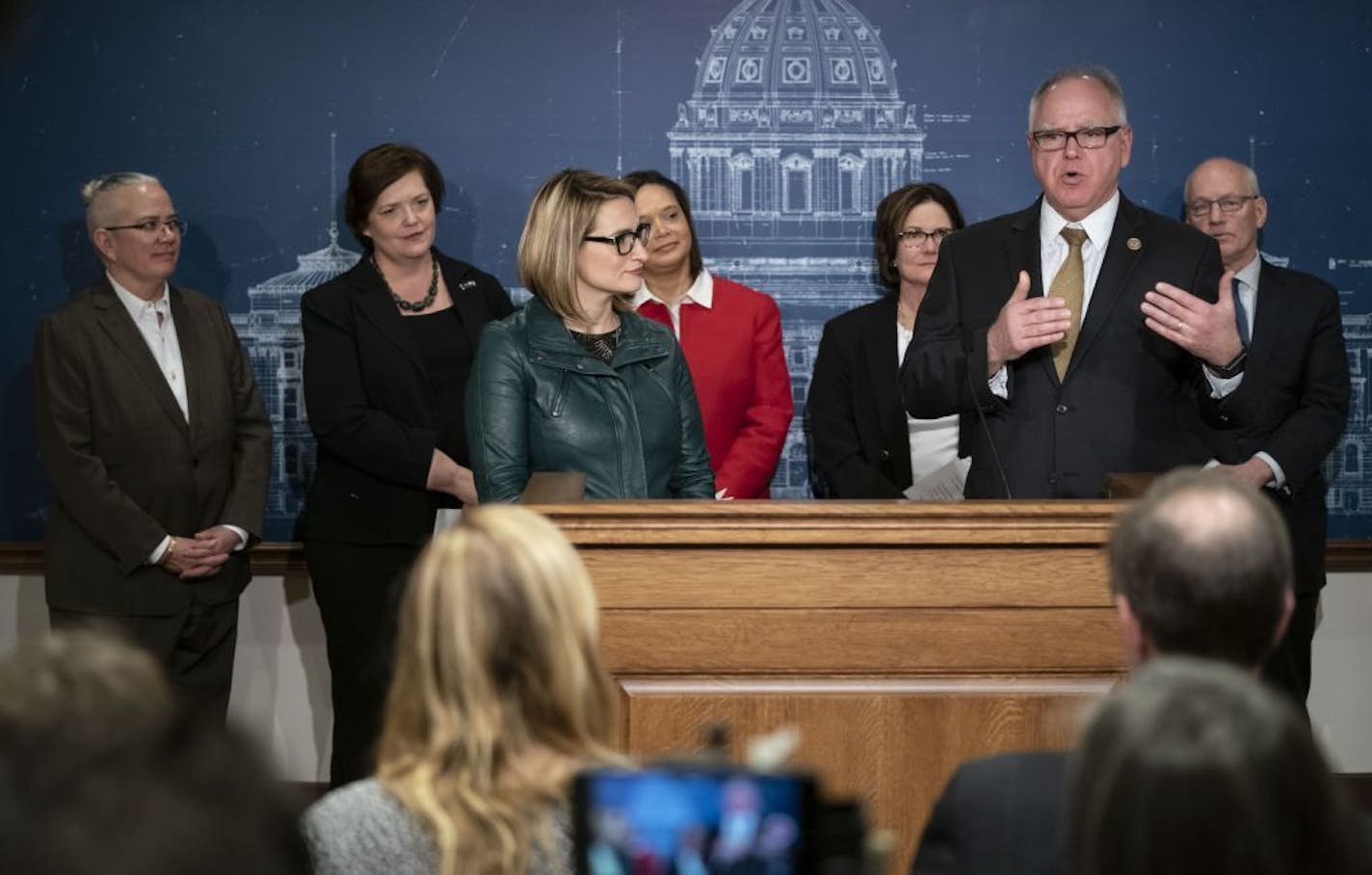 From the back left Jennifer Ho, Housing Finance Agency, Margaret Anderson Kelliher, Department of Transportation, Alice Roberts-Davis, Department of Administration, Nora Slawik, Metropolitan Council, and Myron Frans, Department of Management, stood behind Governor-elect Tim Walz and Lt. Governor-elect Peggy Flanagan at the State Capitol in St. Paul, Minn., on December 18, 2018.