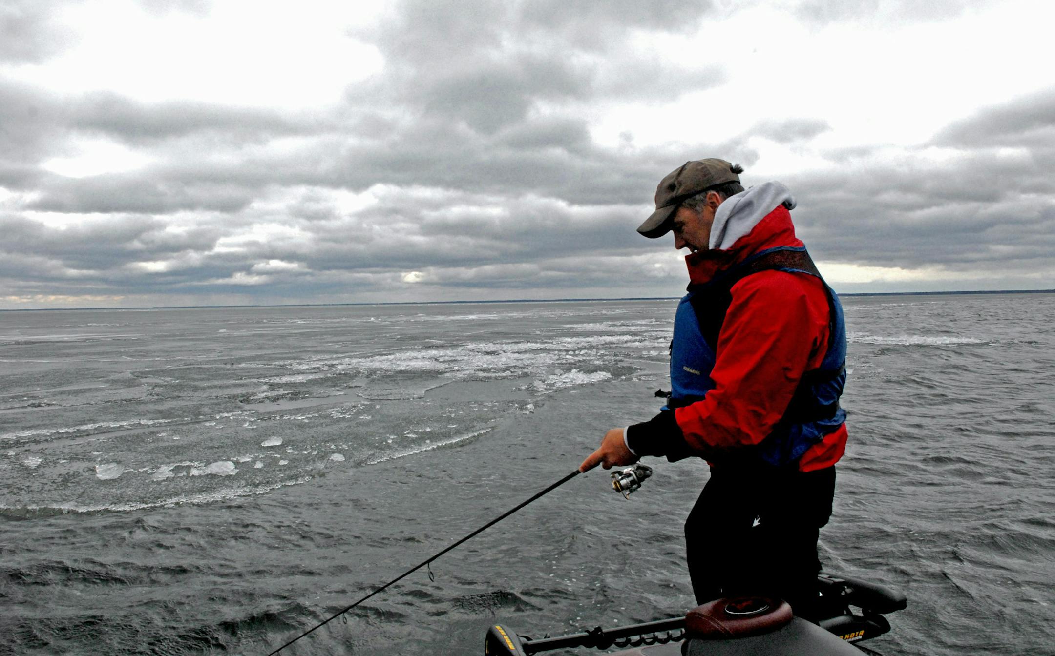 John Heroff of Stillwater tries his luck for walleyes, following the edge of a massive sheet of ice that still covered most of Lake Winnibigoshish on opening day Saturday. Fishing was slow, and anglers were buffetted all day Saturday by frigid winds gusting to 30 miles an hour. ORG XMIT: MIN1305111210580863