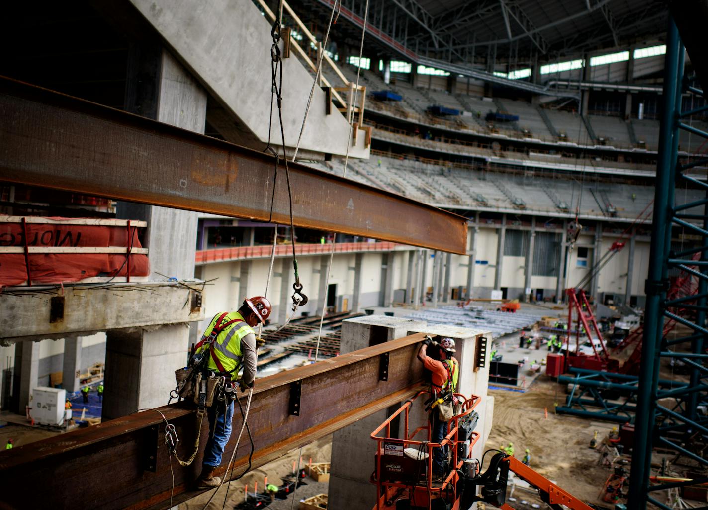 Steel beams are moved into place in the midsection of the stadium. ] GLEN STUBBE * gstubbe@startribune.com Monday, July 20, 2015 A tour of the USBank Stadium. It has a roof made of ETFE, or ethylene-tetra-fluoro-ethylene.