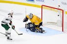Minnesota Wild defenseman Dmitry Kulikov (7) scores a goal against Nashville Predators goaltender David Rittich (33) in overtime of an NHL hockey game