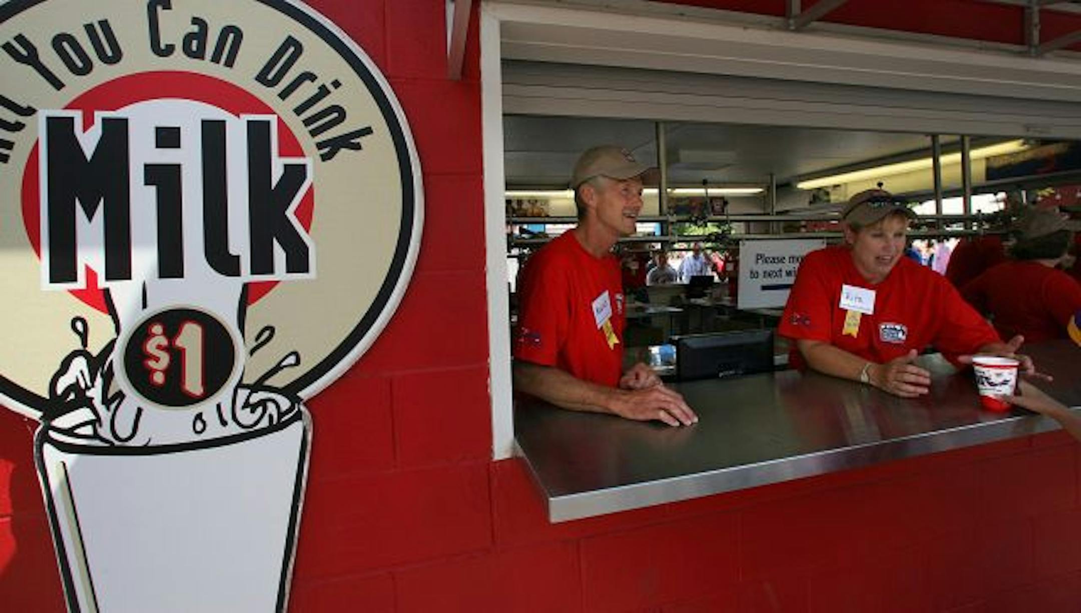 Dairy farmers Maurie and Rita young sell milk at the All You Can Drink booth at the Minnestoa State Fair.