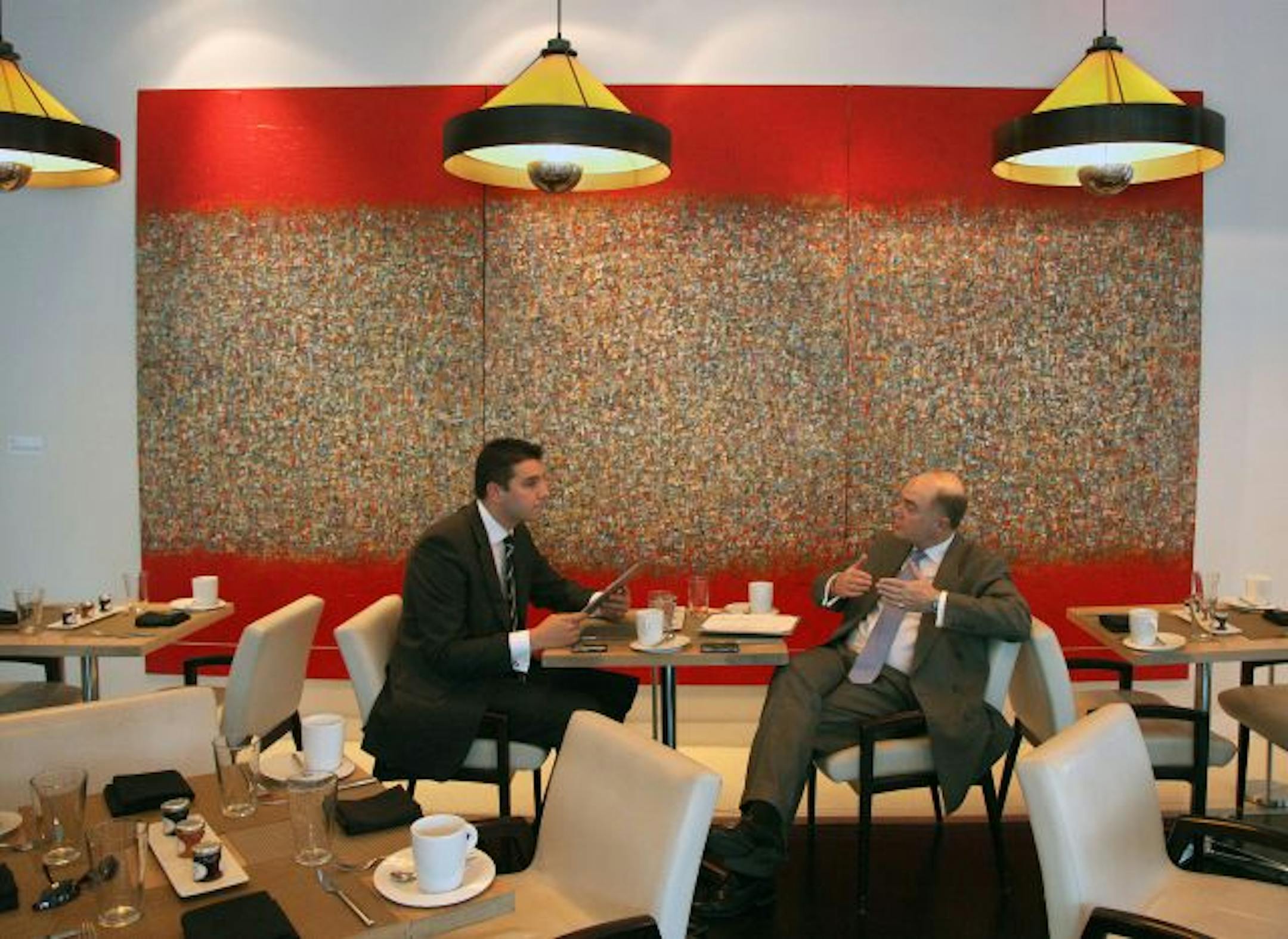 London businessmen Tom Cox, left, and Clive L. Moore start their day with breakfast at the Chambers. Behind them, "WS578" by Yehan Wang.