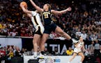 Taylor Woodson (21) makes a play for Michigan against Iowa during the Big Ten women's basketball tournament at Target Center on March 9.