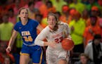 Farmington Tigers forward Rose Wille (23) drove towards the net late in the second half while trailed by St. Michael-Albertville Knights forward Lily 