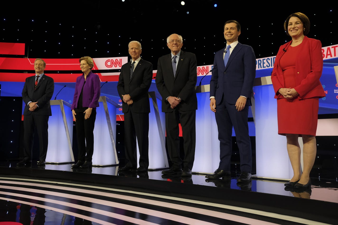 Democratic presidential candidates during the debate at Drake University in Des Moines, Iowa, Jan. 14, 2020. From left: Tom Steyer; Sen. Elizabeth Warren (D-Mass.); Former Vice President Joe Biden; Sen. Bernie Sanders (I-Vt.); Former Mayor Pete Buttigieg of South Bend, Ind.; Sen. Amy Klobuchar (D-Minn.). The debates have functioned like a de facto national primary, conducted through the media and polls, which whittled a score of candidates on the stage in June down to six Tuesday night. (Jordan