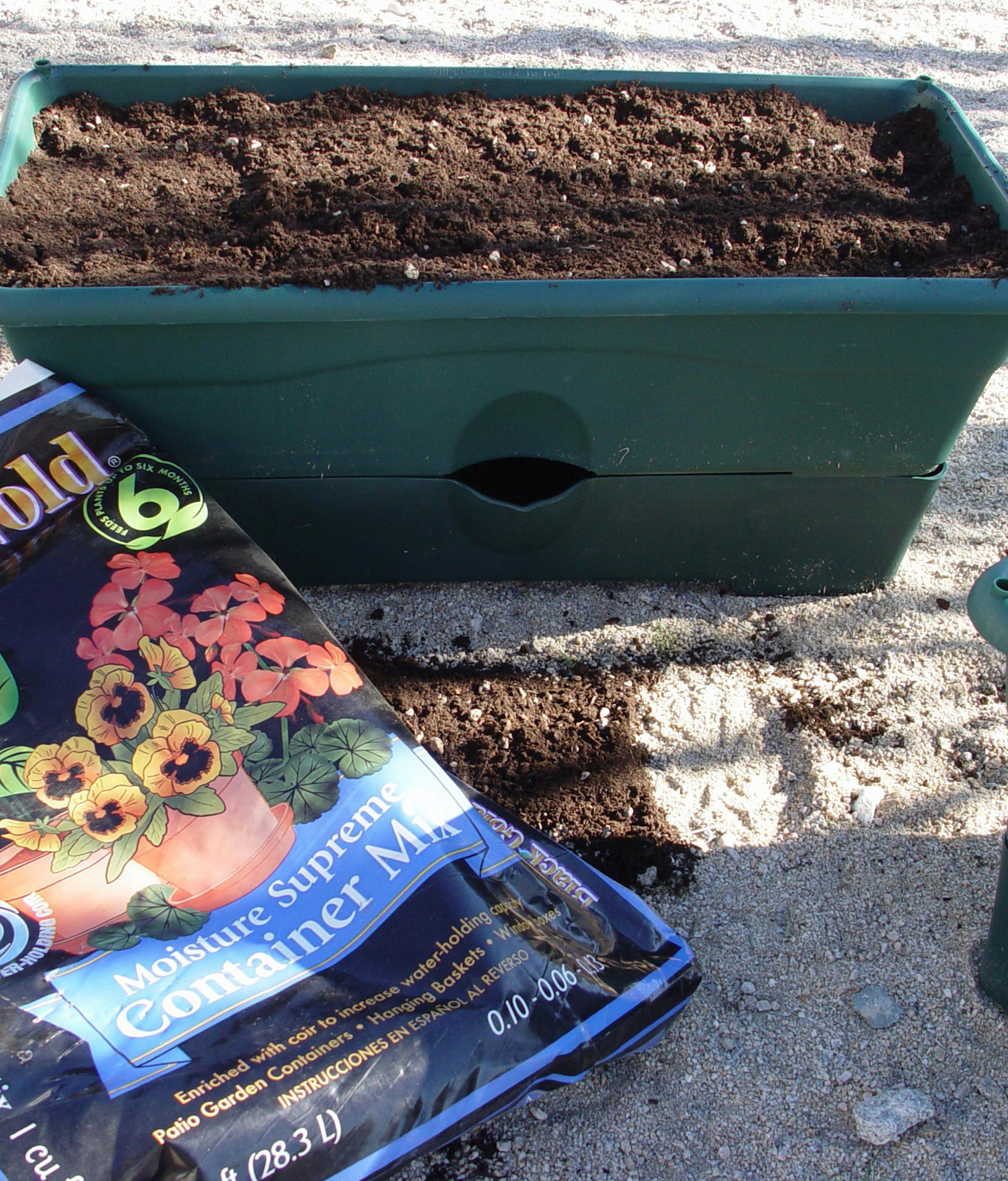 This self-watering container features a four-gallon reservoir on the bottom filled through a hole in the side. (Handout/TNS) ORG XMIT: 1167204