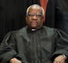 FILE -- Associate Justice Clarence Thomas joins the rest of the Supreme Court justices in sitting for a group photo in Washington on Nov. 30, 2018. On