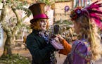 This image released by Disney shows Johnny Depp as the Mad Hatter, left, and Mia Wasikowska as Alice in a scene from "Alice Through the Looking Glass,