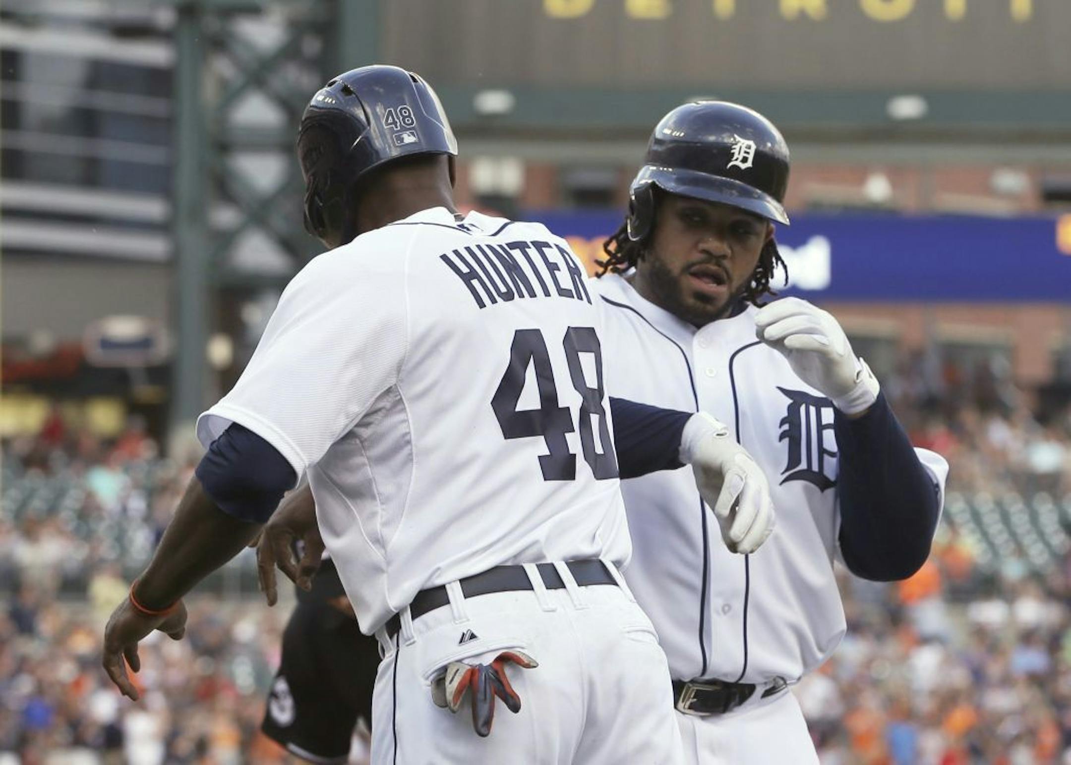 Detroit Tigers' Prince Fielder is greeted by orii Hunter after scoring on a two-run home run off Chicago White Sox starting pitcher Dylan Axelrod during the first inning of a baseball game in Detroit, Wednesday, July 10, 2013.