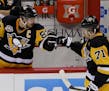 Pittsburgh Penguins' Sidney Crosby (87) greets center Evgeni Malkin (71) after Malkin scored a goal to tie the game against the Ottawa Senators during