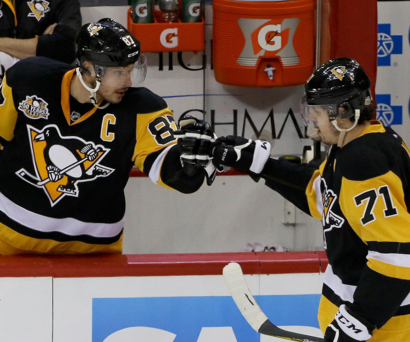 Pittsburgh Penguins' Sidney Crosby (87) greets center Evgeni Malkin (71) after Malkin scored a goal to tie the game against the Ottawa Senators during the third period of Game 1 of the Eastern Conference final in the NHL hockey Stanley Cup playoffs, Saturday, May 13, 2017, in Pittsburgh. (AP Photo/Gene J. Puskar)