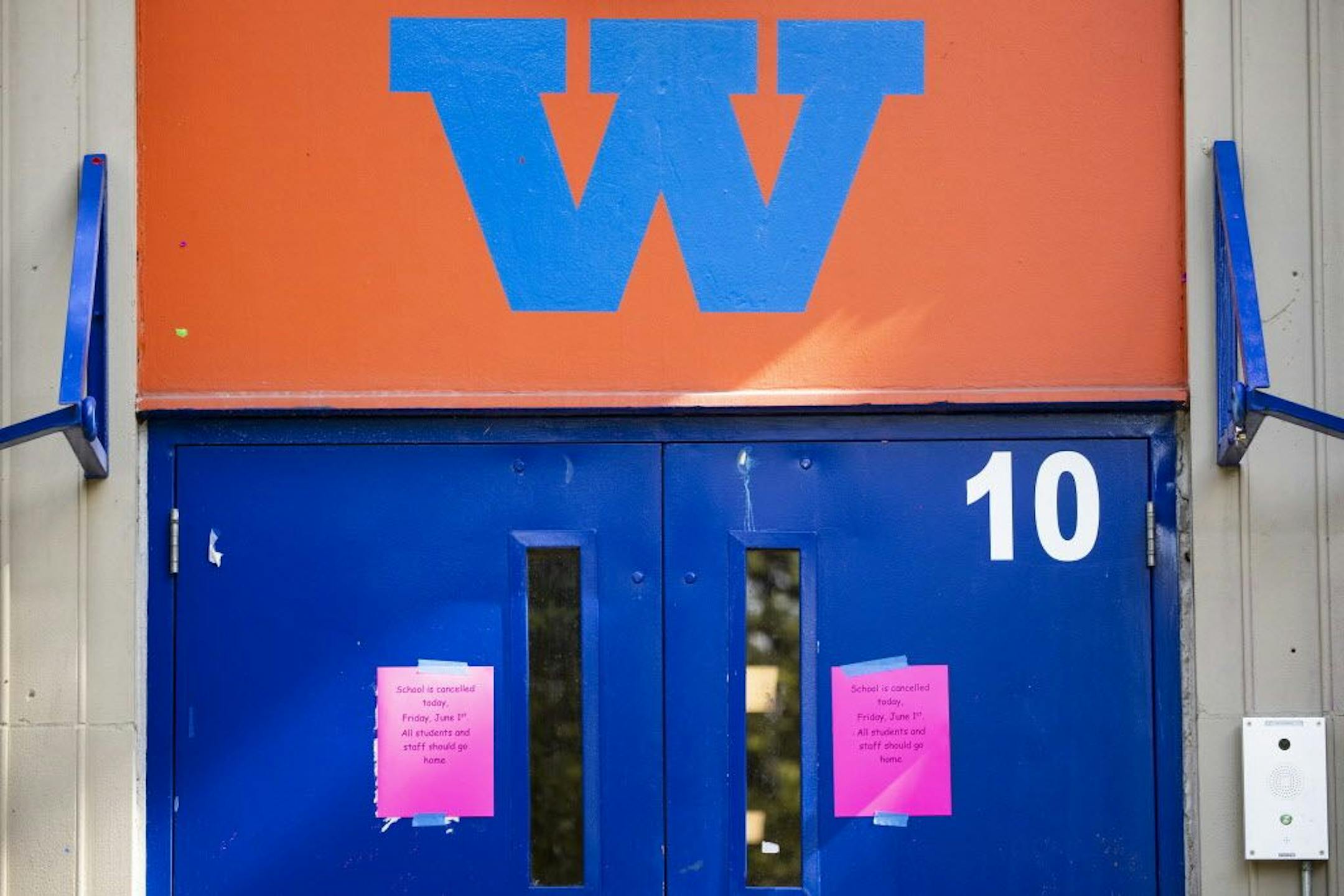 A sign on the entrance at Minneapolis Washburn High School informs students and staff of school cancellation on Friday, June 1, 2018.
