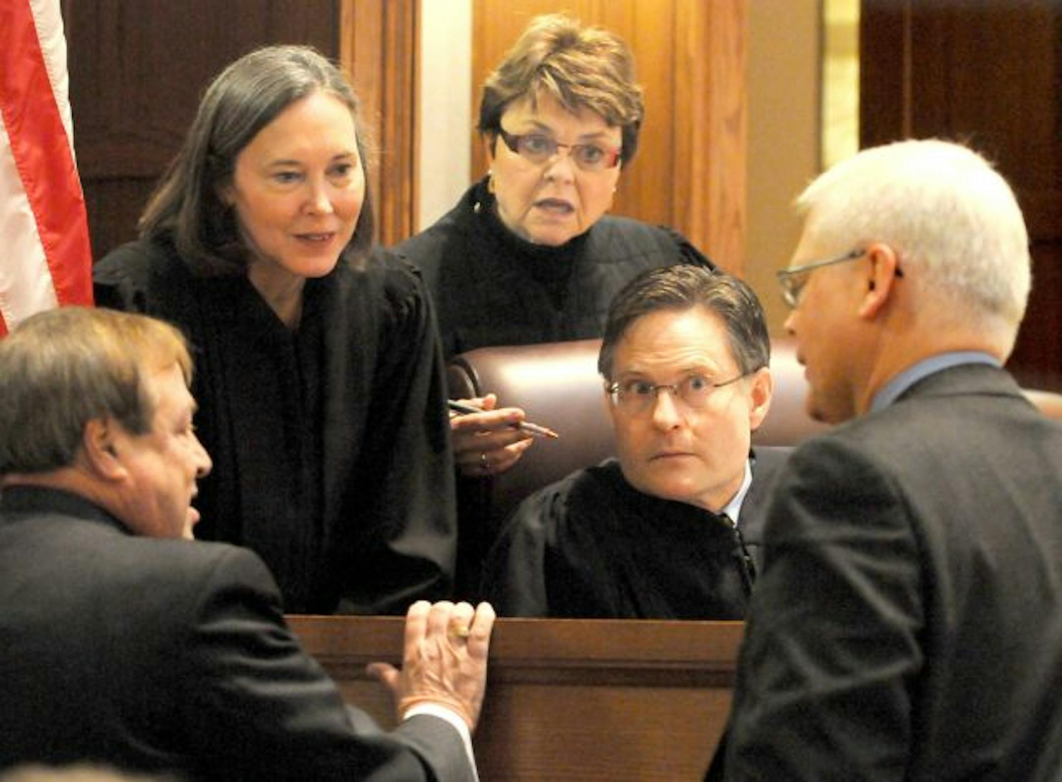 Norm Coleman appealed the Canvassing Board ruling that Franken had more votes. From left, the U.S. Senate election recount trial's three-judge panel, Denise Reilly, Elizabeth Hayden and Kurt Marben, listened while Joe Friedberg, lower left, a lawyer for Norm Coleman, talked after he approached the bench during the testimony of Gary Poser, the state director of elections, at the Minnesota Judicial Center in St Paul. One of Al Franken's attorneys, David Lillehaug, is at lower right.