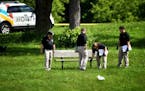 BCA officials investigate the scene of an officer-involved shooting in Bassett Creek Park in Crystal on Wednesday.