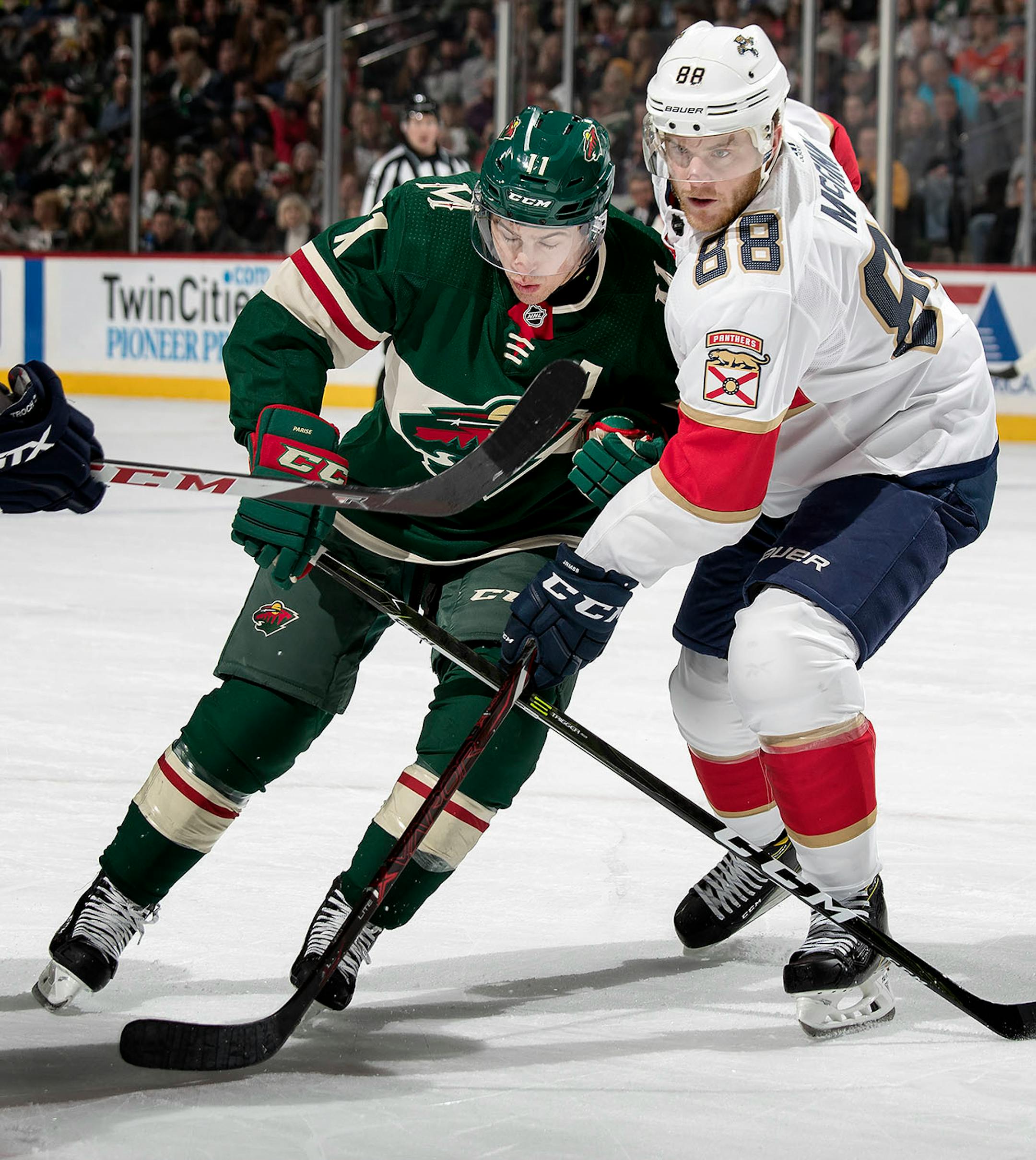 Zach Parise (11) and Jamie McGinn (88) fought for position in the first period.