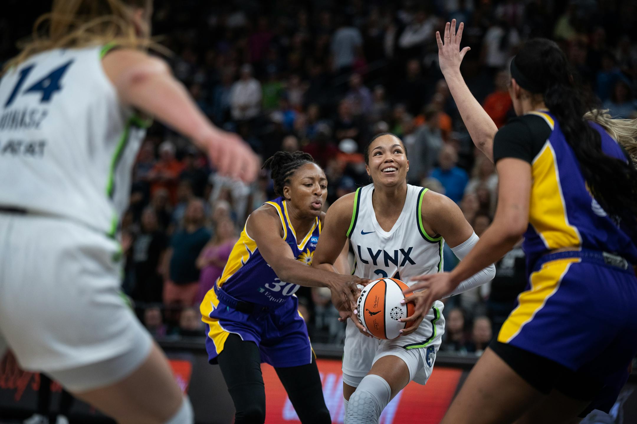 Minnesota Lynx forward Napheesa Collier (24) looks for an opening shot while defended by Los Angeles Sparks forward Nneka Ogwumike (30) in the first half.
