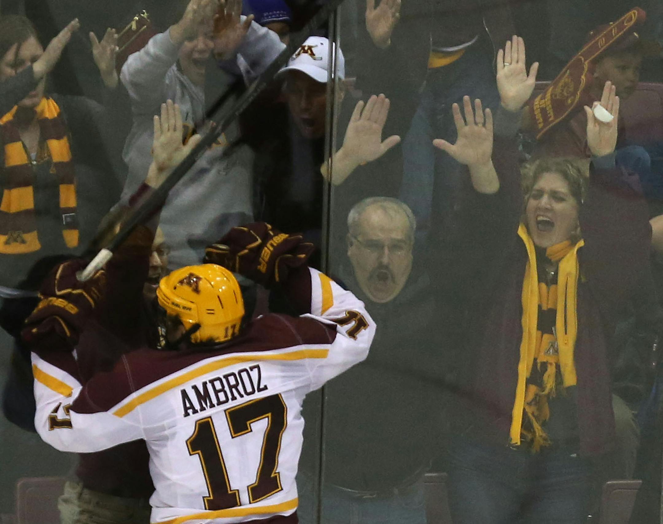 Gophers Seth Ambroz celebrated with fans after he scored the winning goal against Wisconsin in the third period at Mariucci Arena in Minneapolis, Min., Saturday, November 30, 2013. Gophers won over Wisconsin 4-3. ] (KYNDELL HARKNESS/STAR TRIBUNE) kyndell.harkness@startribune.com
