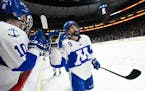 Minnetonka forward Bobby Brink celebrated with teammates after scoring the game-tying goal in the first period against Duluth East in the Class 2A tit
