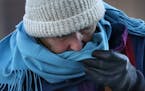 A woman uses her scarf to wipe away a tear brought on by frigid weather, Thursday, Dec. 15, 2016, in Portland, Maine. Much of the United States will g