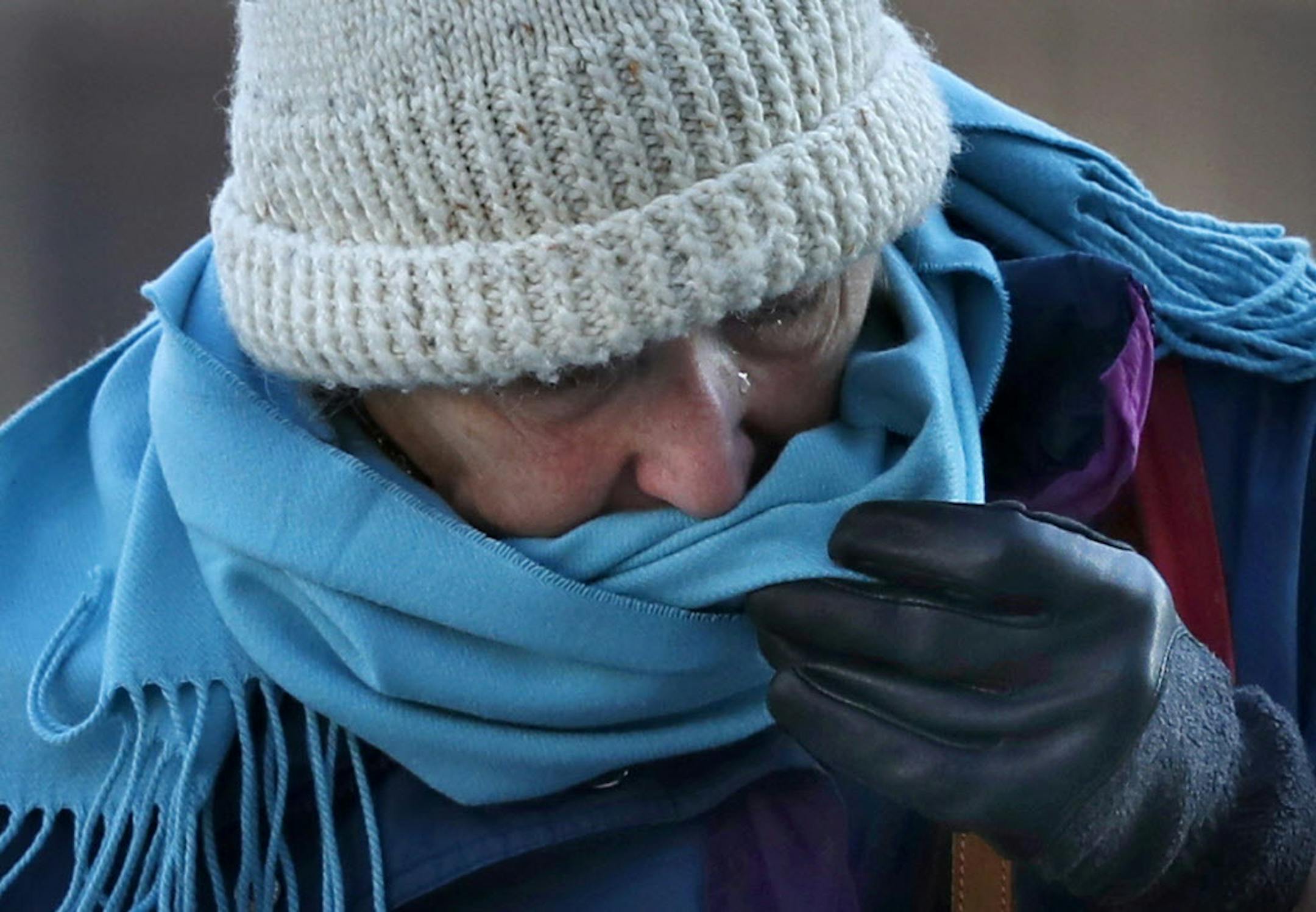 A woman uses her scarf to wipe away a tear brought on by frigid weather, Thursday, Dec. 15, 2016, in Portland, Maine. Much of the United States will get another smack of cold air next week.