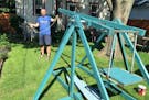 Dan Wenkel in his St. Paul backyard wth the trebuchet he and his wife built nearly 20 years ago.