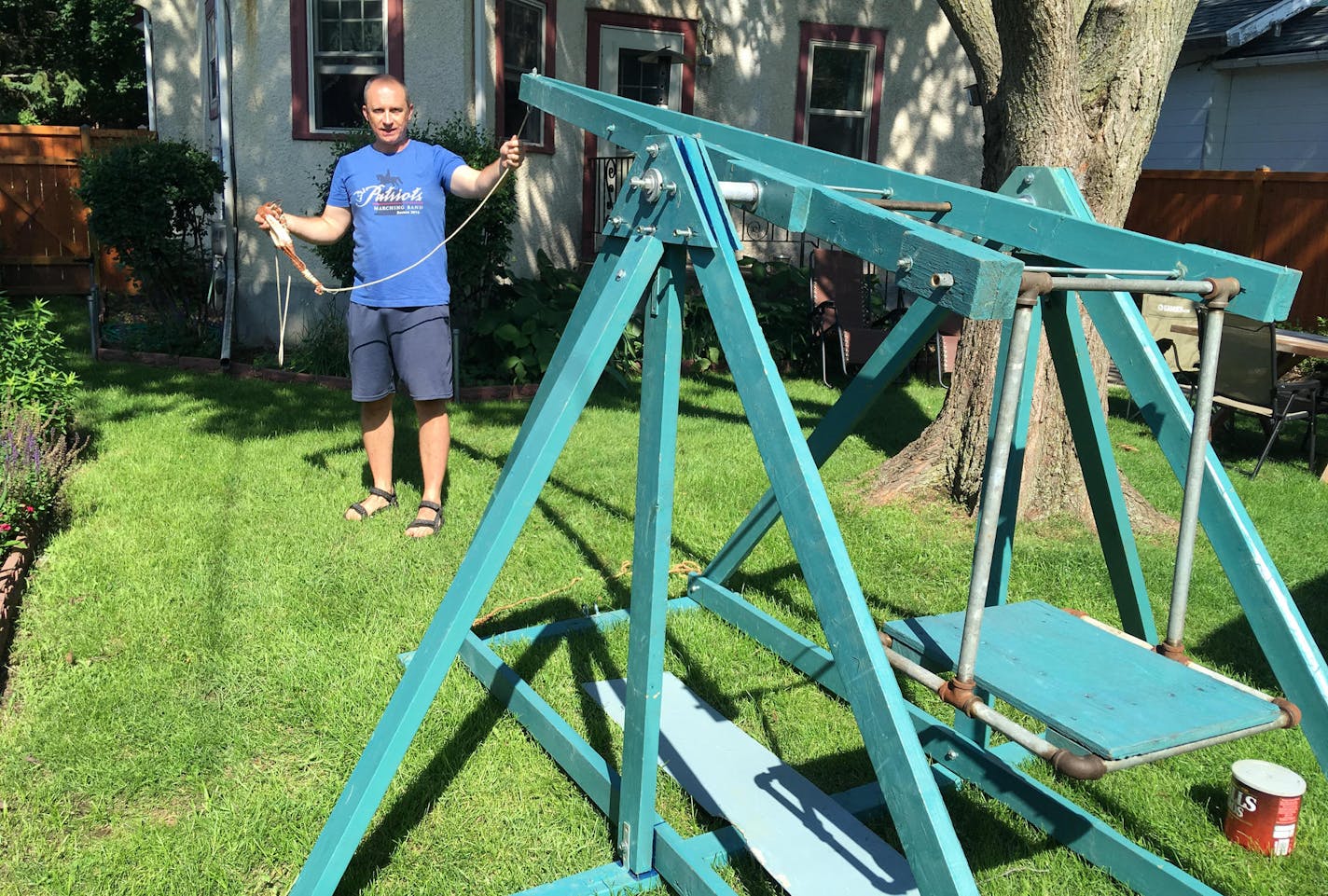 Dan Wenkel in his St. Paul backyard wth the trebuchet he and his wife built nearly 20 years ago.