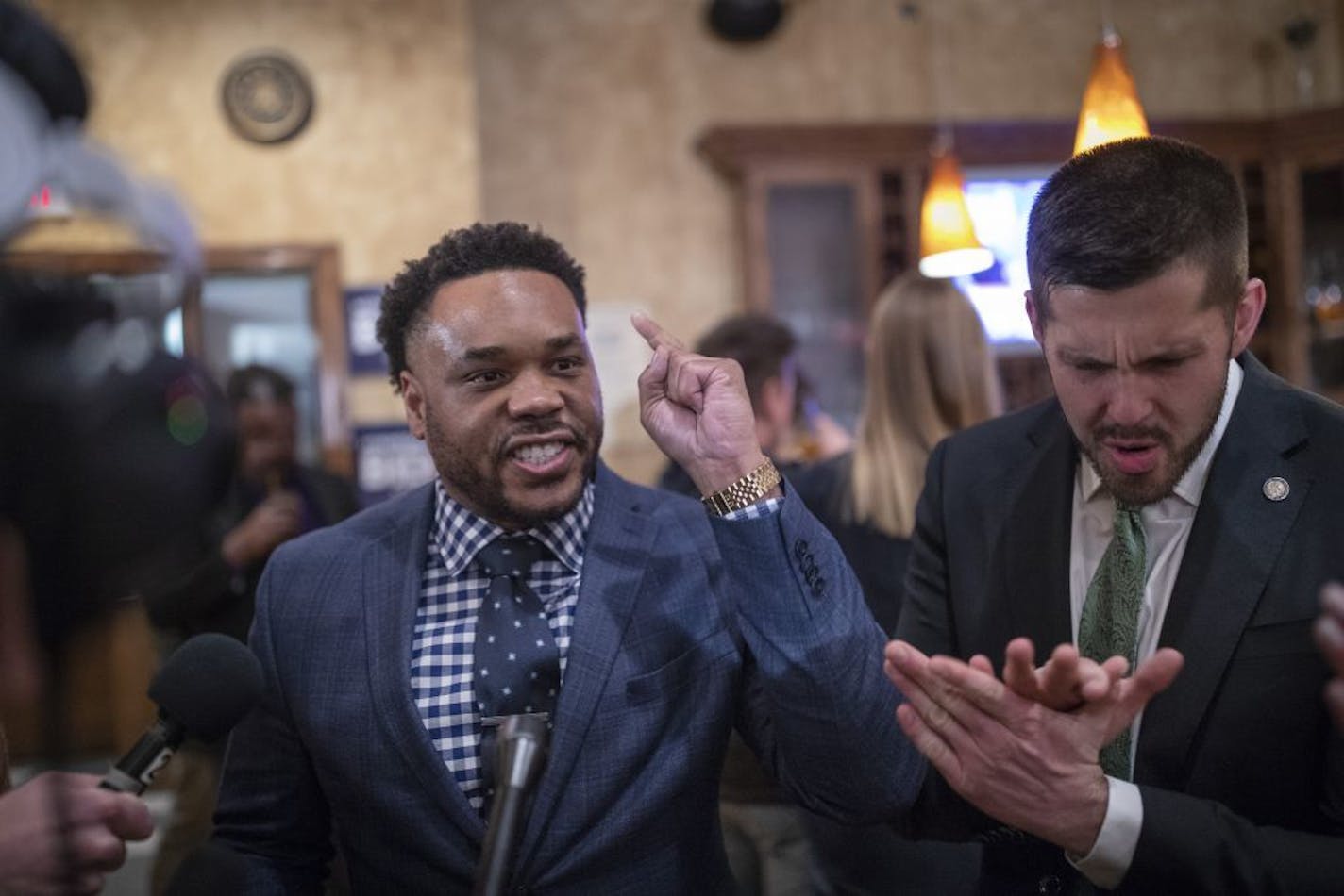 Corey Day, Joe Biden's Minnesota senior adviser, left, and Rep. Dan Wolgamott of St. Cloud celebrated Tuesday after hearing that the former vice president had won the state's Democratic primary.