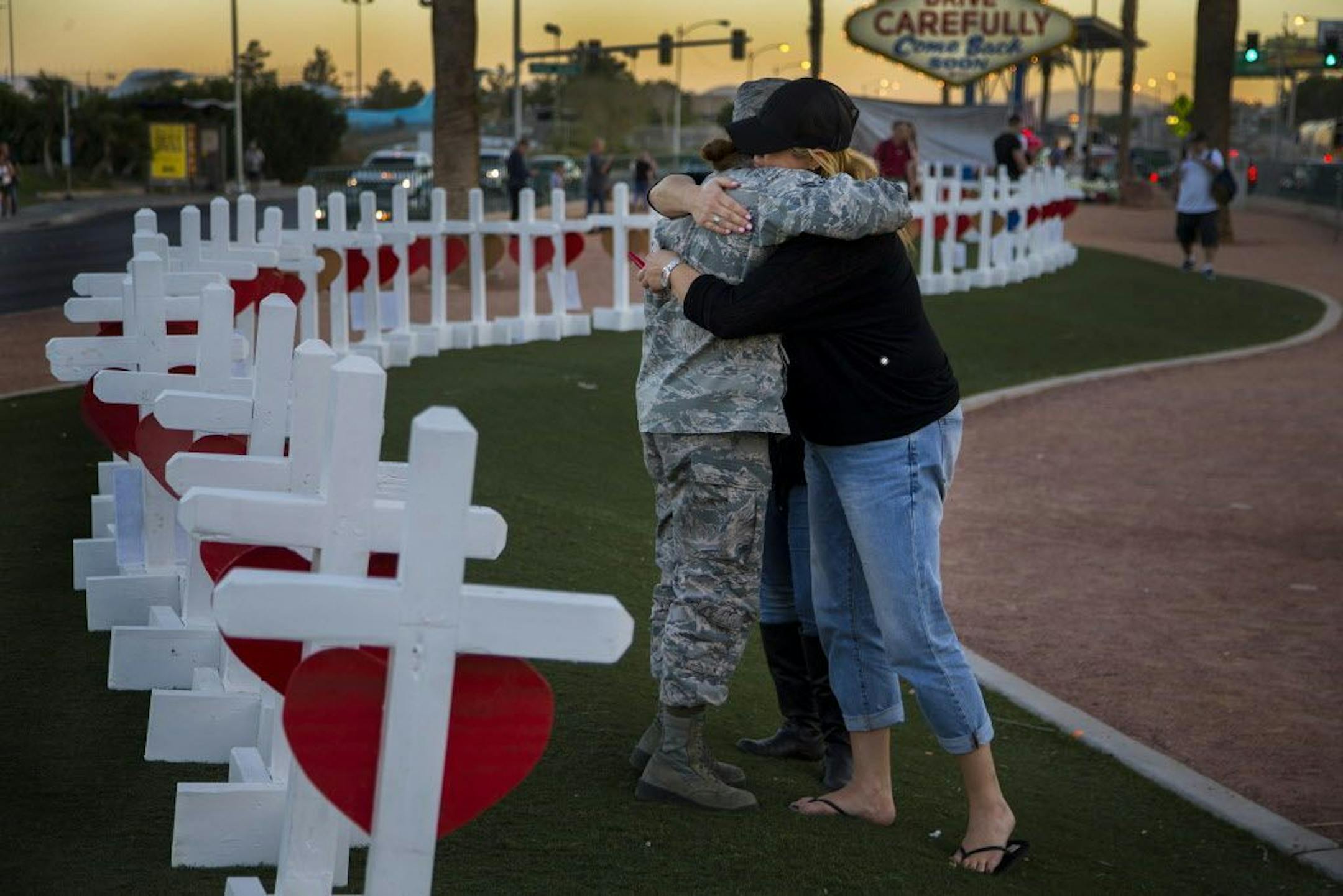 Sharon Black of Las Vegas, right, hugs Airmen First Class Williams of the U.S. Air Force after they were both overcome with emotion while viewing wooden crosses bearing the names of those killed during Sunday's mass shooting off Las Vegas Boulevard on October 5, 2017 in Las Vegas, Nevada. Greg Zanis of Illinois drove all night to deliver the homemade crosses. Williams did not want her first name used.