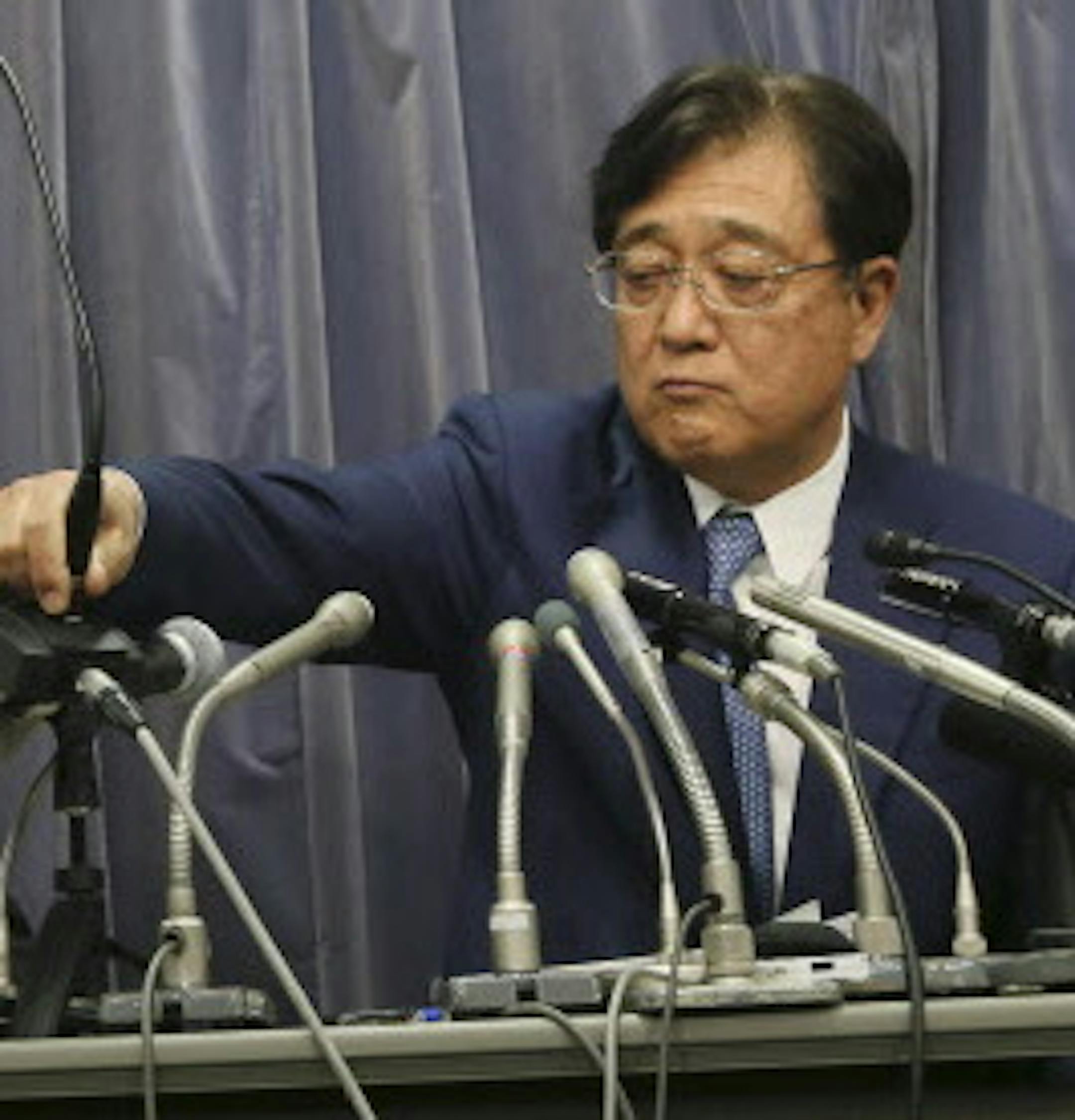 Mitsubishi Motors Corp. Chairman and CEO Osamu Masuko, right, passes a microphone to President Tetsuro Aikawa during their press conference in Tokyo, Wednesday, May 11, 2016. Mitsubishi Motors, the Japanese automaker under investigation for lying about fuel economy data for some models, said Wednesday such tampering is suspected in all of its vehicles sold in Japan. (AP Photo/Eugene Hoshiko)