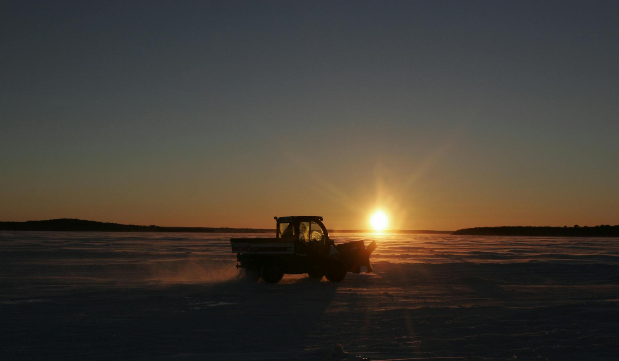 Doug Smith/Star Tribune; Jan. 22, 2014; A small snowplow cruises across a frozen Leech Lake at sunset recently. The windchill was near minus-30.