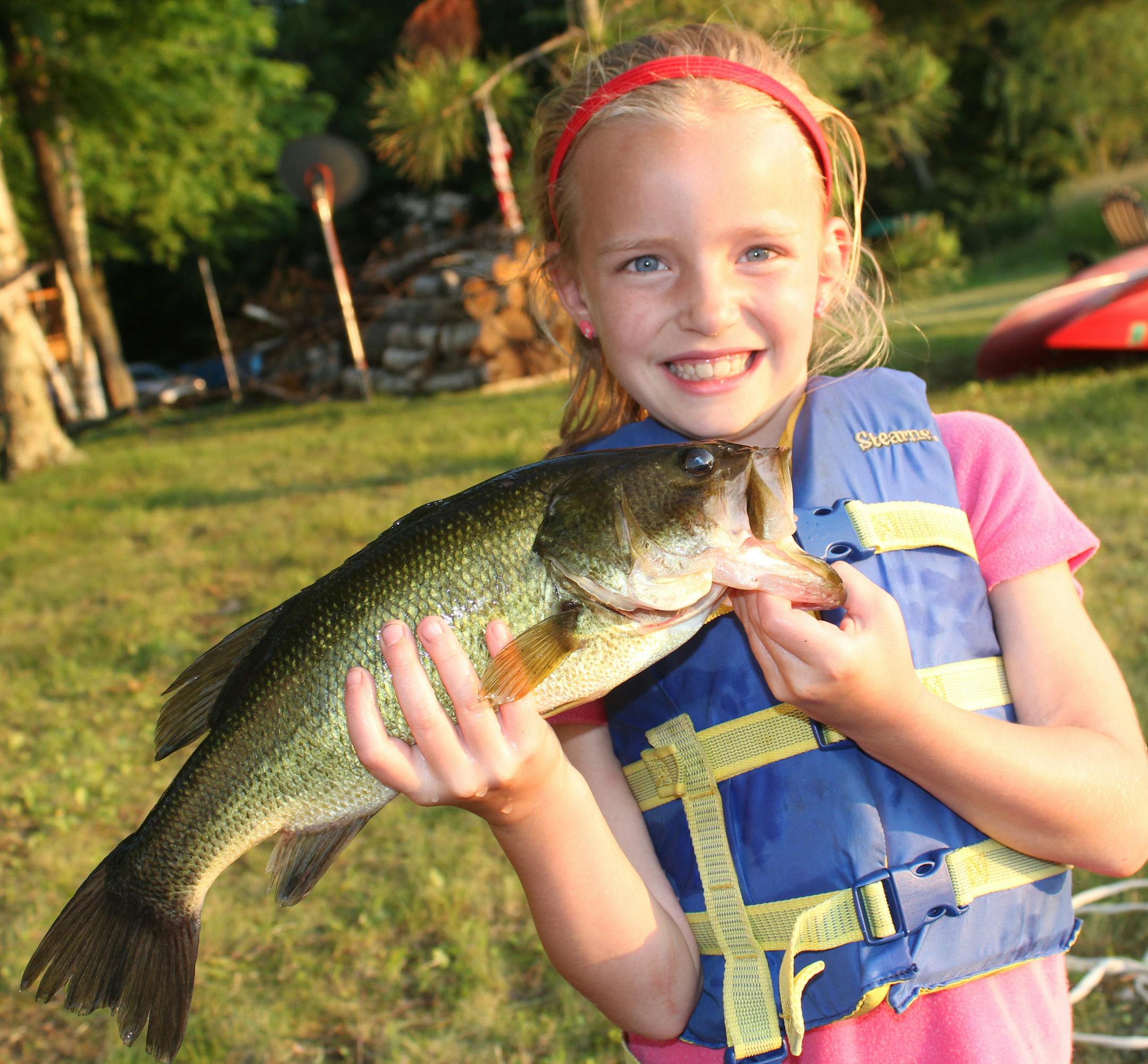 DANDY BUCKETMOUTH Grace Swiggum, 8, of Hopkins caught this 17-inch largemouth bass on Shirt Lake near Deerwood.
