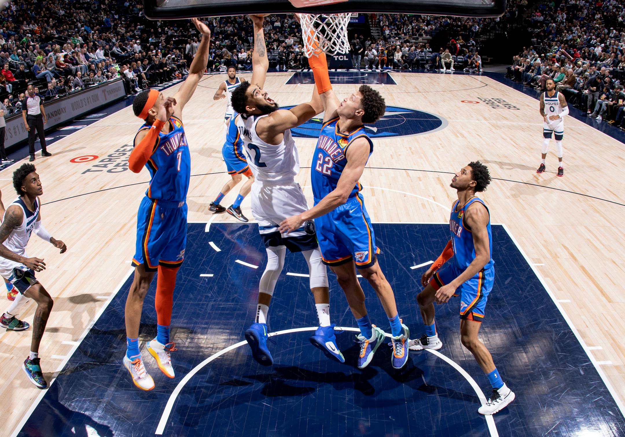 Karl Anthony-Towns (32) of the Minnesota Timberwolves attempts a shot in while defended by Isaiah Roby (22) of the Oklahoma City Thunder.