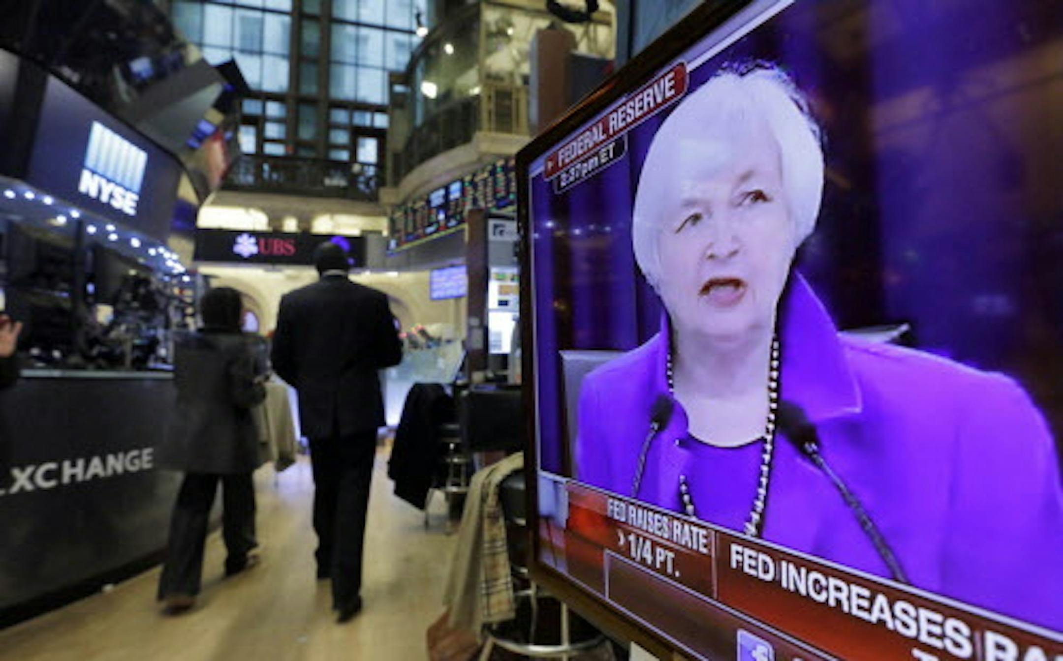 Federal Reserve Chair Janet Yellen's Washington news conference is shown on a television screen on the floor of the New York Stock Exchange, Wednesday, Dec. 16, 2015. The Fed's move to lift its key rate by a quarter-point to a range of 0.25 percent to 0.5 percent ends an extraordinary seven-year period of near-zero rates that began at the depths of the 2008 financial crisis. (AP Photo/Richard Drew)