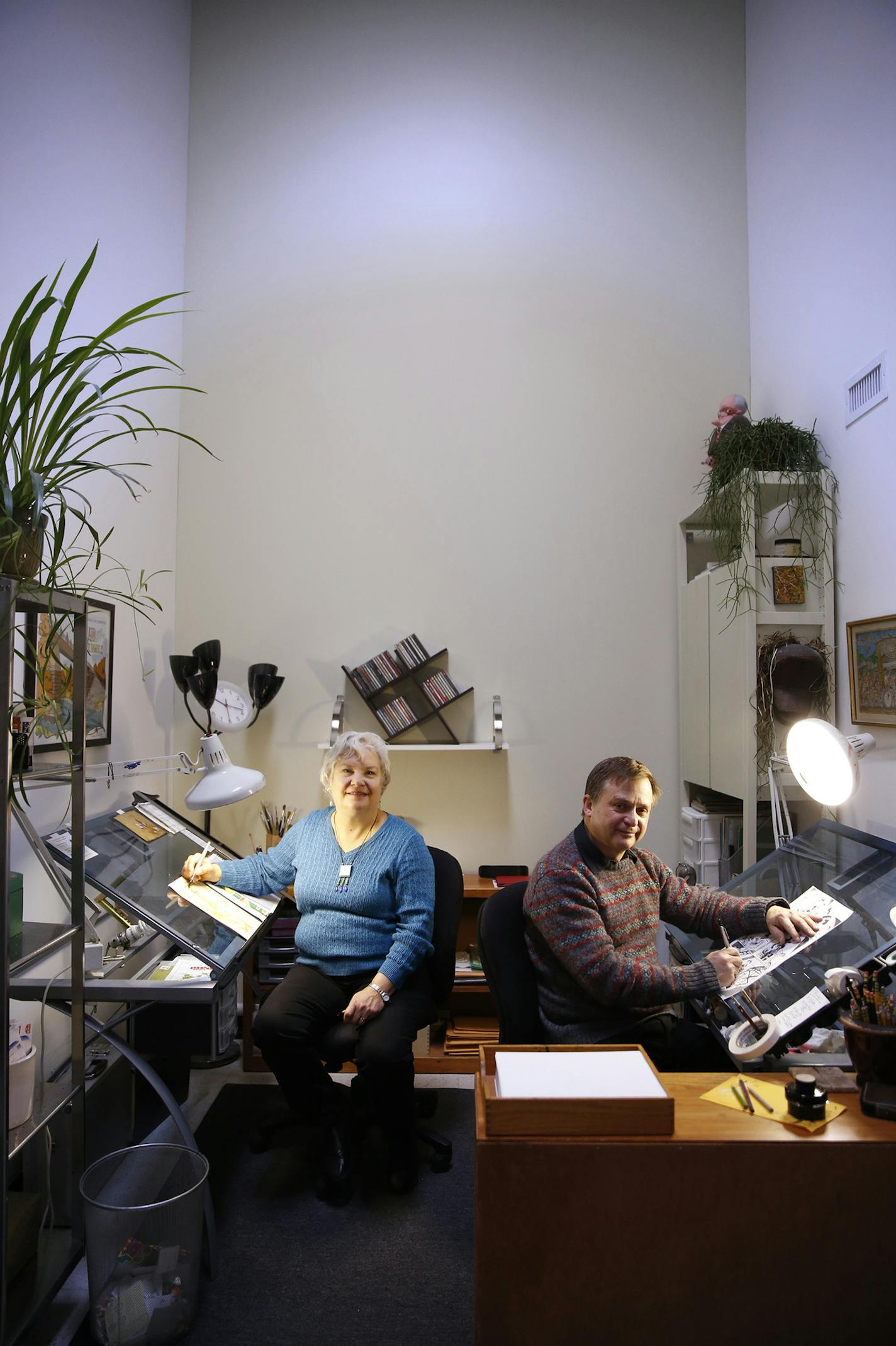 Ken and Roberta Avidor pose in the drawing studio inside their condo at Union Depot in downtown St. Paul on Friday, December 26, 2014. ] LEILA NAVIDI leila.navidi@startribune.com / BACKGROUND INFORMATION: Ken and Roberta Avidor are part of the Twin Cities growing urban-sketching movement, they have captured Mississippi River flooding, people waiting at bus stops and, most recently, life on St. Paul's Green Line light rail trains.